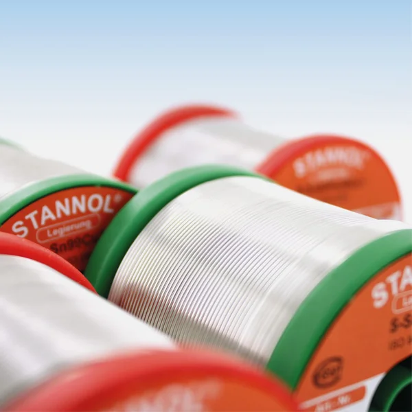The picture shows several Stannol solder wire reels. They are lying on their side so that the solder wire is clearly visible.