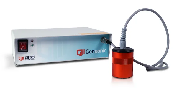 The picture shows the Gensonic from Gen3 Systems, a light grey, rectangular device connected by cable to a red, cylindrical ultrasound device.