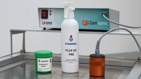 Auf dem Bild sind das Ultraschall-Reinigungsgerät Gensonic von Gen3 inklusive orangefarbenem Ultraschallschwingkopf, eine grüne Lotpastendose mit SP6000 Lotpaste von Stannol und eine weiße Sprühflasche Flux-Ex Pre-Reiniger von Stannol zu sehen.