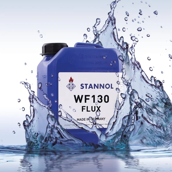 The picture shows a blue flux canister from Stannol. The white label bears the inscription WF130 Flux and the Stannol logo. The canister is surrounded by splashing water.