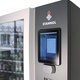The picture shows a section of Stannol's Smart Warehouse: A large vending machine with a viewing window on the left and a display on the right. The Stannol logo can be seen above the display.