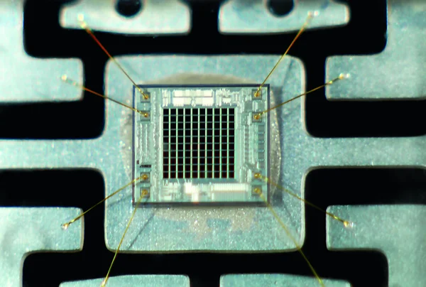 Nahaufnahme eines Mikrochip mit feinen Drähten verbunden.