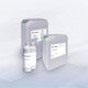 The picture shows three large canisters and two bottles of Flux-Ex cleaning agent from the Stannol brand. The canisters are grey and have green caps, with product names such as ‘Flux-Ex Post Power’ and ‘Flux-Ex Glue’ on the labels. In front of the canisters are two white bottles, one of which has a spray nozzle, also with the Stannol logo and labelling. The products are professional cleaning agents for the soldering industry.