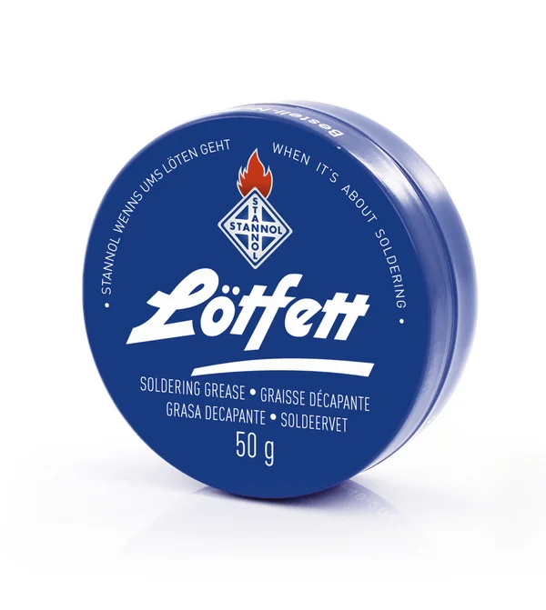 Auf dem Bild ist eine kleine, blaue, metallene Dose mit Stannol Lötfett zu sehen.