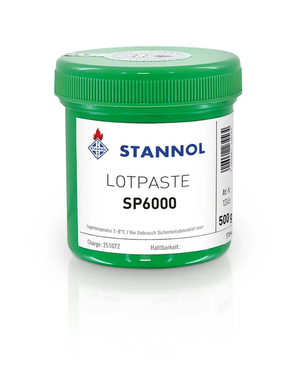The picture shows a green can of Stannol's SP6000 solder paste. There is a white label on the tin with the Stannol logo and product specifications.